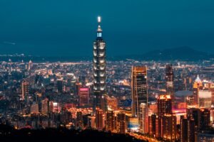 A breathtaking nighttime skyline view of Taipei 101 and surrounding illuminated skyscrapers in Taiwan.