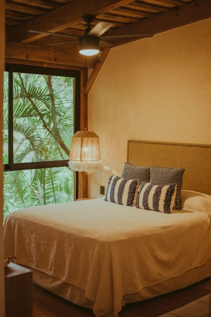 pexels photo 16436913 16436913 Warm and inviting rustic bedroom interior with natural light and greenery view.
