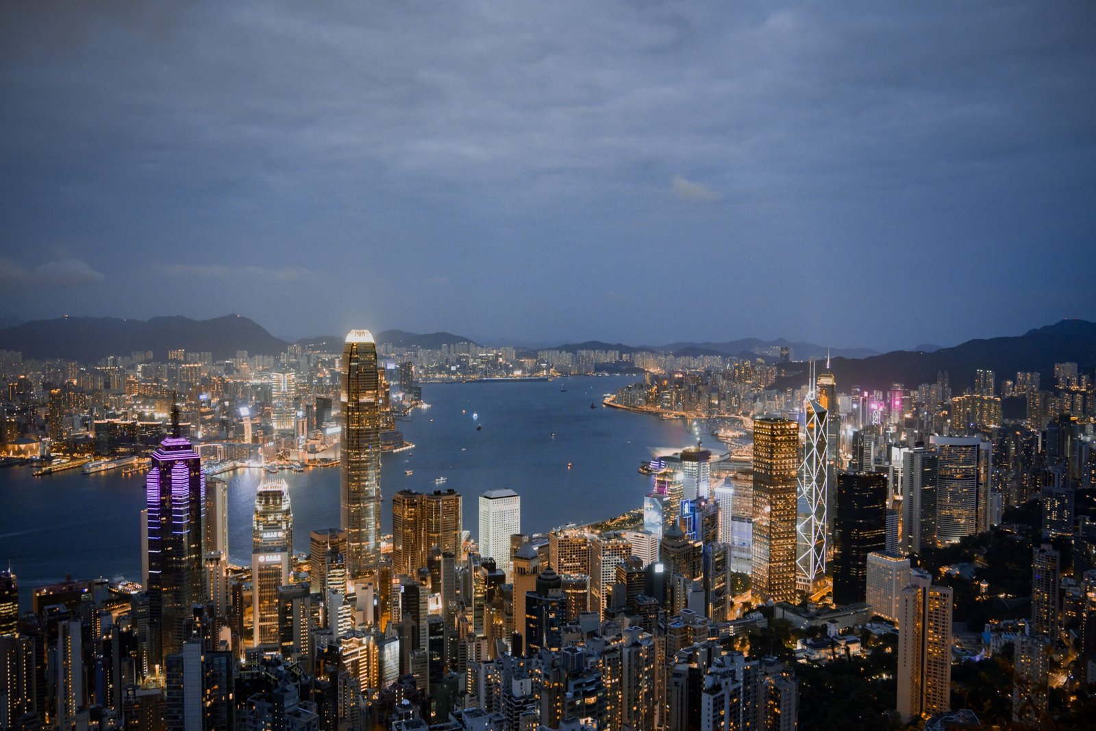 4D3N Hong Kong with Disneyland A breathtaking view of Hong Kong's illuminated skyline and harbor at night.